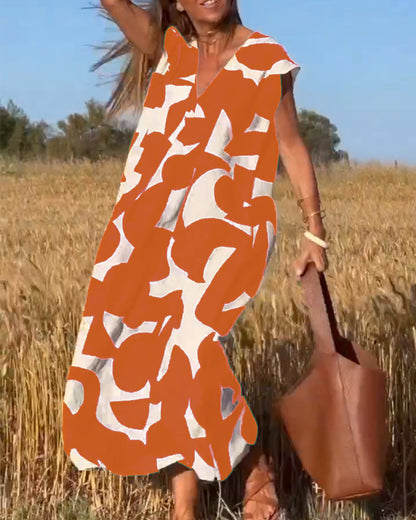 Margaux – Wijdvallende jurk met grafische print en V-hals